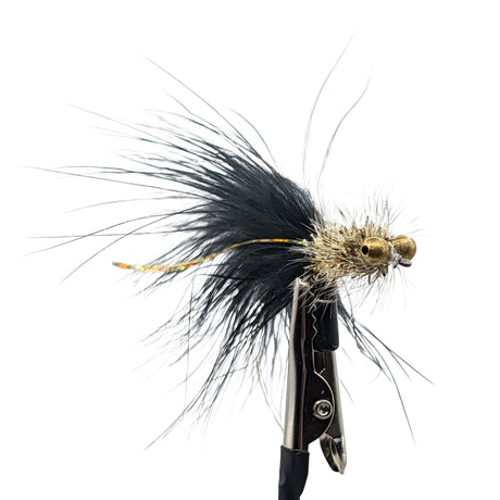 Fishing streamer with black and gold details on a white background