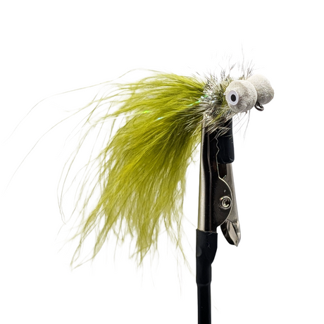 Fishing lure with green feathers and a metal hook on a white background