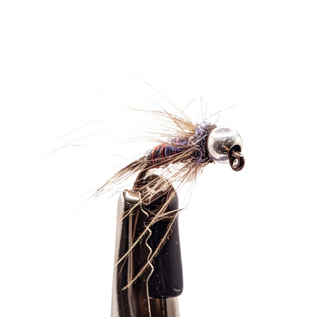 Fishing nymph on a hook against a white background