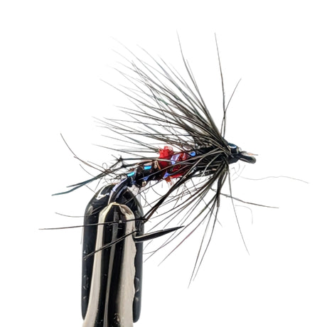 Close-up of a detailed fly fishing fly on a light grey background