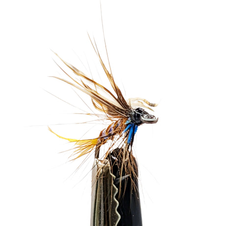 Close-up of a detailed sea trout fly on a white background