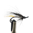 sea trout fly with black and yellow feathers on a white background