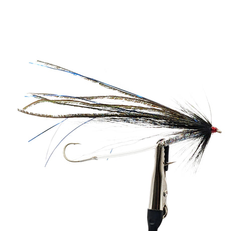 sea trout fly with detailed hook and feathers on a white background